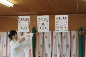 A local Shinto priest introducing the traditional Kiriko paper-cutting culture of Minamisanriku