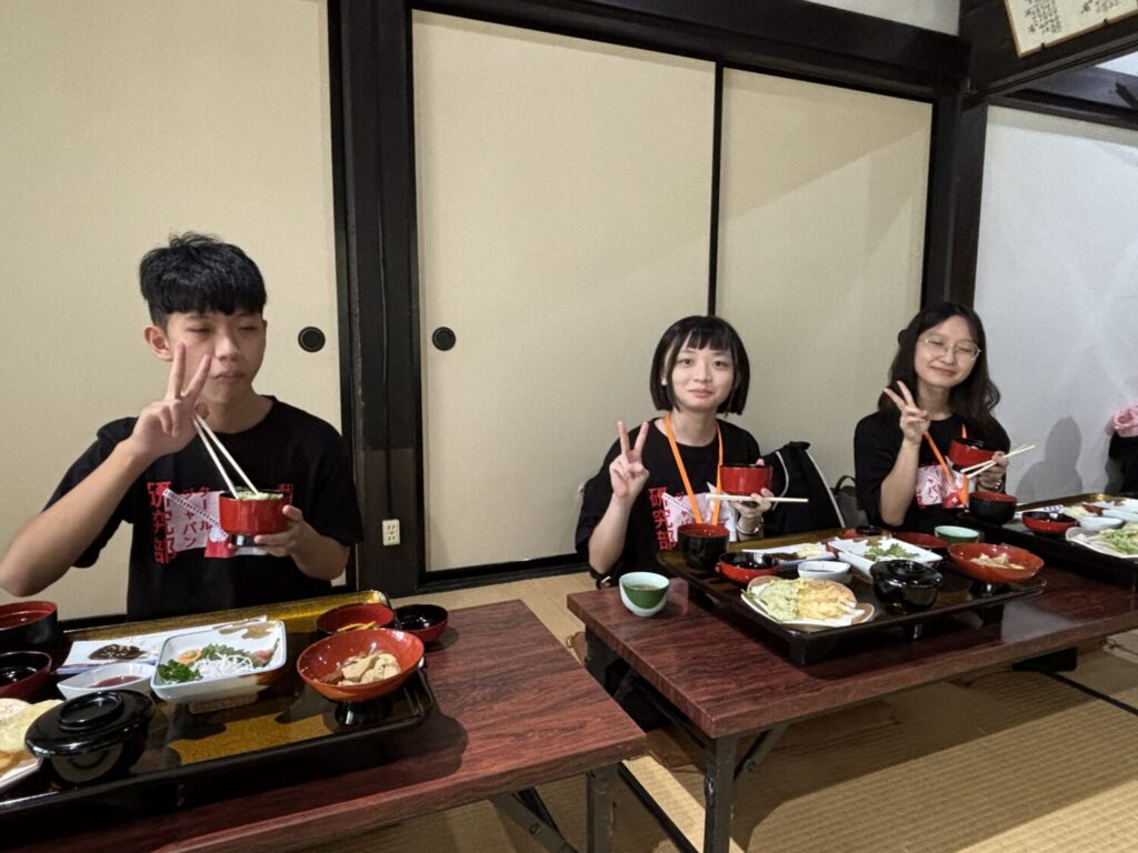 Participants enjoying a relaxing traditional lunch on tatami mats inside a historic rural house