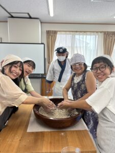 Participants experiencing traditional Japanese Soba noodle making from scratch