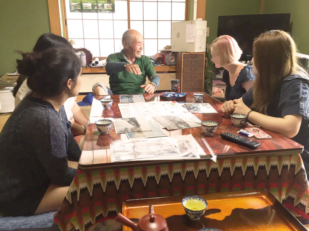 Visitors enjoying a warm conversation and genuine cultural exchange with their local host family in Minamisanriku
