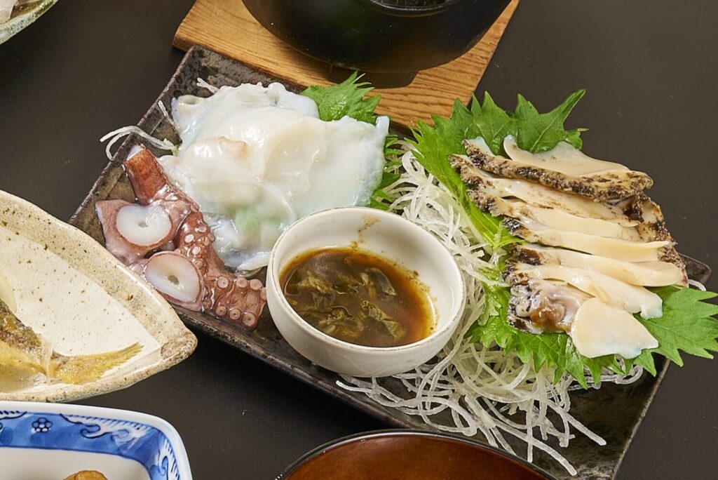 Freshly sliced premium abalone and local Shizugawa octopus sashimi