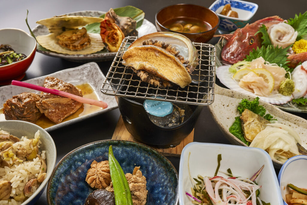 A special seasonal dinner course featuring fresh, premium abalone grilled directly at the table (Odori-yaki)