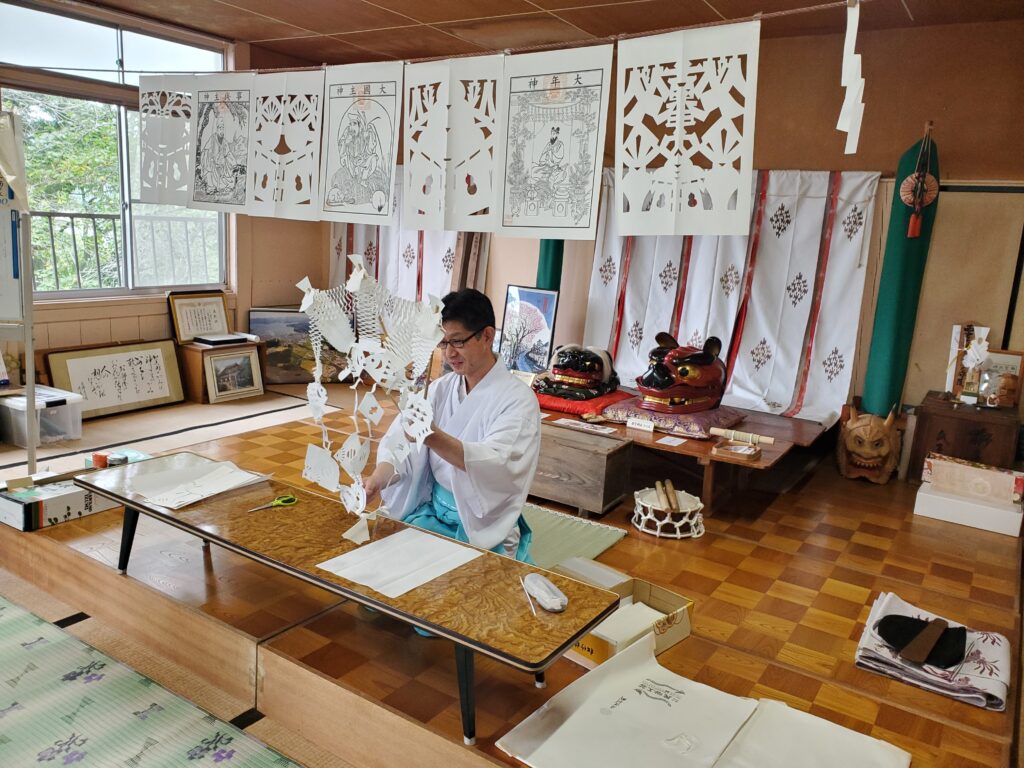 Delicate hand-cutting of traditional Kiriko paper patterns