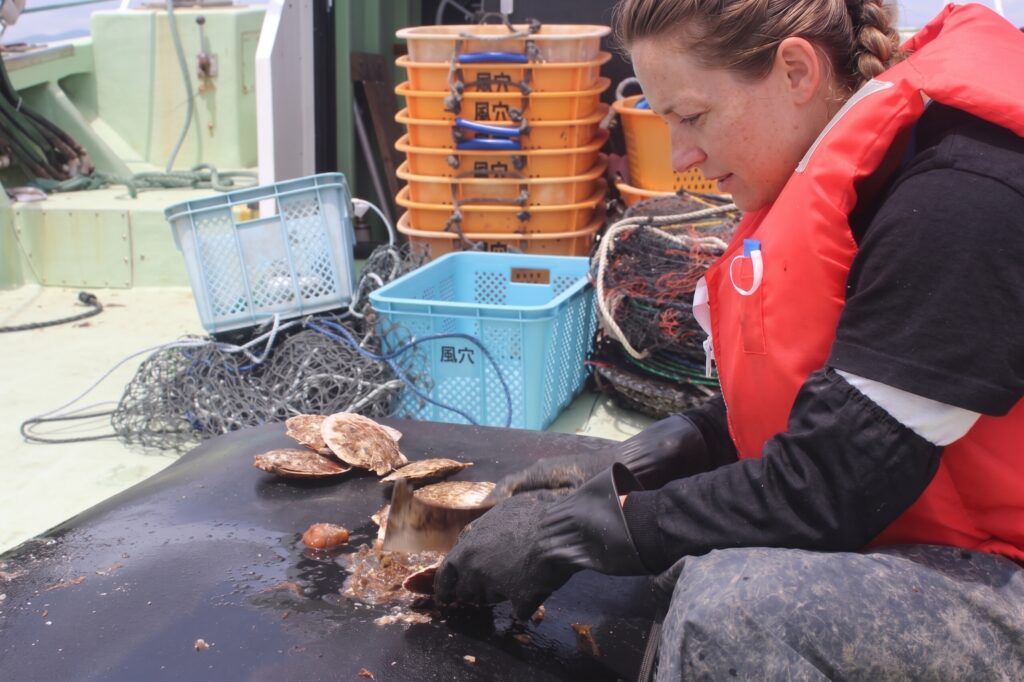 Tour participants experiencing hands-on fisherman's work aboard a traditional fishing vessel