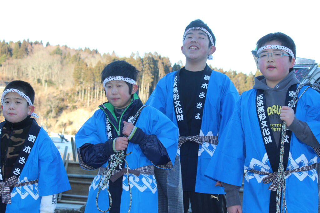 Local children wearing traditional custom Sasayo Happi coats for the historic winter festival