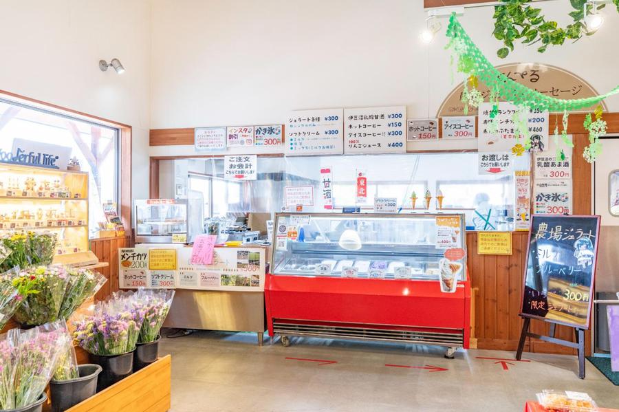The warm interior of the Kumperu store, offering a variety of fresh local produce and homemade pork products