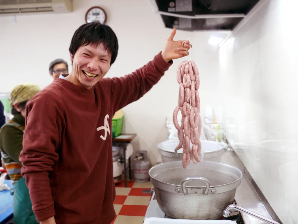 Freshly handmade sausages being boiled to perfection during the popular sausage-making experience